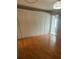 Bedroom featuring hardwood floors, full wall closet and access to the sunroom at 1811 Bedford Ln # 162, Sun City Center, FL 33573