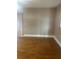 Bedroom featuring hardwood floors and view of window with vertical blinds at 1811 Bedford Ln # 162, Sun City Center, FL 33573