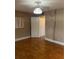 Bedroom featuring hardwood floors, large windows, and decorative light fixture at 1811 Bedford Ln # 162, Sun City Center, FL 33573