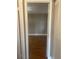 A simple bedroom with hardwood floors viewed through a doorway with an open closet at 1811 Bedford Ln # 162, Sun City Center, FL 33573