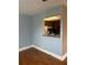 Dining room showcasing wood floors and a passthrough to the adjacent kitchen area at 1811 Bedford Ln # 162, Sun City Center, FL 33573