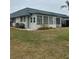 Attractive home exterior featuring an enclosed porch and meticulously kept landscaping at 1811 Bedford Ln # 162, Sun City Center, FL 33573