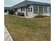 Charming single-story home with a well-maintained lawn and enclosed porch at 1811 Bedford Ln # 162, Sun City Center, FL 33573