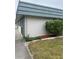 Side view of home with green shrubbery and lawn at 1811 Bedford Ln # 162, Sun City Center, FL 33573