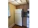 Spacious kitchen featuring wood cabinets and a white refrigerator at 1811 Bedford Ln # 162, Sun City Center, FL 33573