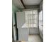 Laundry area featuring stacked washer and dryer with a window at 1811 Bedford Ln # 162, Sun City Center, FL 33573