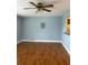 The living room has wood flooring, a ceiling fan, and a light blue painted wall at 1811 Bedford Ln # 162, Sun City Center, FL 33573