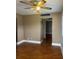 Spacious living room with rich wood flooring and ceiling fan at 1811 Bedford Ln # 162, Sun City Center, FL 33573