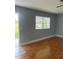 Cozy living room with wood floors, a window with blinds, and a neutral color palette at 1811 Bedford Ln # 162, Sun City Center, FL 33573