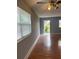 A spacious living room with wood flooring, a ceiling fan, and natural light from the windows at 1811 Bedford Ln # 162, Sun City Center, FL 33573