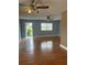 The living room features hardwood floors, neutral paint, a ceiling fan, and natural light at 1811 Bedford Ln # 162, Sun City Center, FL 33573