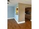The living room has hardwood floors, a window, and an opening that goes into the kitchen at 1811 Bedford Ln # 162, Sun City Center, FL 33573