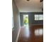 Bright living room featuring a window, light-colored walls, and wood-look flooring at 1811 Bedford Ln # 162, Sun City Center, FL 33573