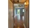 View from closet showing the light-filled living room with hardwood floors and ceiling fan at 1811 Bedford Ln # 162, Sun City Center, FL 33573