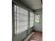 View of enclosed porch area with vertical blinds and door leading to outside at 1811 Bedford Ln # 162, Sun City Center, FL 33573