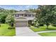 Charming two-story home with a well-manicured lawn and attached two-car garage at 19308 Sunset Bay Dr, Land O Lakes, FL 34638