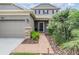 Inviting front entry with well maintained landscaping and a brick walkway at 19308 Sunset Bay Dr, Land O Lakes, FL 34638