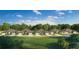 Attractive new homes line a green lawn with mature trees under a sunny sky at 2016 Sidney St, Clearwater, FL 33763
