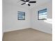 Bright bedroom featuring dual windows, neutral walls, and new flooring at 2540 W Pine St, Tampa, FL 33607