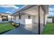 Home's exterior featuring a covered patio, green lawn, and blue sky at 2540 W Pine St, Tampa, FL 33607