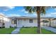 Charming single-story home with a well-manicured front yard and a lovely palm tree at 2540 W Pine St, Tampa, FL 33607