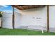 Outdoor shower area featuring a white privacy fence, concrete flooring, and green grass at 2540 W Pine St, Tampa, FL 33607
