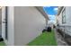 Home's exterior featuring a green lawn and a white wall with stairs at 2540 W Pine St, Tampa, FL 33607