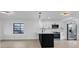 Modern kitchen with stainless steel appliances, white cabinets, and unique light fixtures at 2540 W Pine St, Tampa, FL 33607