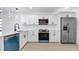 Modern kitchen featuring white cabinets, stainless steel appliances, and sleek countertops at 2540 W Pine St, Tampa, FL 33607