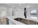 Close-up of a kitchen island with a stainless steel sink and modern faucet at 2540 W Pine St, Tampa, FL 33607