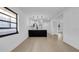 Open-concept living space with light wood floors and modern lighting fixtures at 2540 W Pine St, Tampa, FL 33607