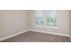 Neutral bedroom with carpet and two windows providing ample natural light at 26836 Dove Dr, Punta Gorda, FL 33955