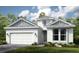 Charming single Gathering home displaying a two car garage, neutral colors, and lush green landscaping at 26836 Dove Dr, Punta Gorda, FL 33955