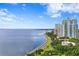 Scenic view of waterfront condos along the bay with lush trees lining the highway under a blue sky at 3301 Bayshore Blvd # 1908B, Tampa, FL 33629