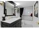Classic bathroom design with a black vanity, tiled shower, and black and white patterned floors at 3301 Bayshore Blvd # 1908B, Tampa, FL 33629