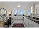Elegant bathroom featuring dual vanities, a makeup desk, and a large window with stunning city views at 3301 Bayshore Blvd # 1908B, Tampa, FL 33629