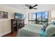 Bedroom with a large window with city views, hardwood floors, and a comfortable queen size bed at 3301 Bayshore Blvd # 1908B, Tampa, FL 33629