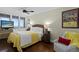 Cozy bedroom with a ceiling fan, light yellow bedding, and beautiful views from the large window at 3301 Bayshore Blvd # 1908B, Tampa, FL 33629
