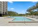 Relaxing community pool area with lounge chairs, umbrellas, and lush landscaping creating a serene retreat at 3301 Bayshore Blvd # 1908B, Tampa, FL 33629