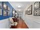 Long hallway featuring hardwood floors, blue accent wall, and elegant lighting fixtures at 3301 Bayshore Blvd # 1908B, Tampa, FL 33629