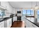 Modern kitchen with stainless steel appliances, white cabinetry, black countertops, and island at 3301 Bayshore Blvd # 1908B, Tampa, FL 33629
