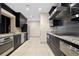 Modern kitchen featuring stainless steel appliances, dark wood cabinets, and granite countertops at 3301 Bayshore Blvd # 1908B, Tampa, FL 33629