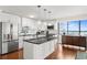 Bright kitchen features stainless steel appliances, white cabinetry, and an island with black countertop at 3301 Bayshore Blvd # 1908B, Tampa, FL 33629