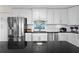 Modern kitchen features stainless steel appliances, black countertops, and white cabinetry at 3301 Bayshore Blvd # 1908B, Tampa, FL 33629