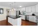Bright kitchen boasts white cabinetry, stainless appliances, a center island with stone counters and hardwood floors at 3301 Bayshore Blvd # 1908B, Tampa, FL 33629