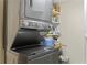 Efficient laundry area with stacked washer and dryer unit and convenient shelving for storage at 3301 Bayshore Blvd # 1908B, Tampa, FL 33629
