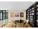 Reading area featuring a round table and chairs with animal art and a large bookcase at 3301 Bayshore Blvd # 1908B, Tampa, FL 33629