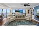 Comfortable living room with recliners, a ceiling fan and a beach scene on the large screen television at 3301 Bayshore Blvd # 1908B, Tampa, FL 33629