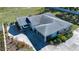 Aerial view of a home showcasing the roof, carports, driveway, and well-maintained landscaping at 4010 N Lockwood Ridge Rd, Sarasota, FL 34234