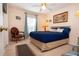 Cozy bedroom featuring a comfortable bed, ceiling fan, and a classic decorative chair at 4010 N Lockwood Ridge Rd, Sarasota, FL 34234
